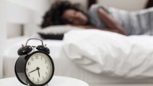 Person sleeping peacefully in bed at night, highlighting how adequate sleep reduces stress and supports healthy digestion and gut health.