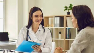 Doctor consulting with a patient about digestive issues, emphasizing the importance of seeking professional help for stress-related gut health problems.
