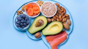 Healthy foods arranged in brain shape symbolizing gut-brain connection.