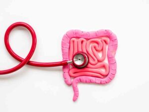 Stethoscope on gut image representing how to improve gut health.