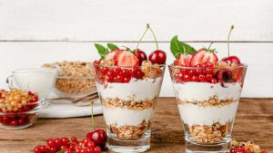 Layered coconut yogurt parfait with fresh berries and granola, a probiotic-rich gut-healing dessert that supports digestion.