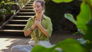 Person meditating at sunrise -morning meditation and mindfulness for gut health and stress reduction.
