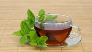 Peppermint tea in a cup, a natural antispasmodic herbal tea that soothes the stomach, relieves cramps, and supports healthy digestion.
