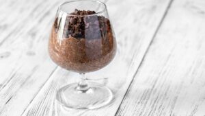 Creamy dark chocolate chia pudding topped with fresh fruit, a fiber-rich gut-friendly dessert that aids digestion.