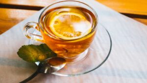 Lemon balm tea in a cup, a gentle herbal tea that calms the stomach, reduces stress, and promotes relaxation naturally.