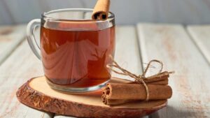 Cinnamon tea in a cup, a warming digestive aid that soothes the stomach and supports healthy digestion naturally.