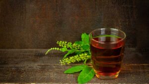 Tulsi tea (Holy Basil) in a cup, an Ayurvedic remedy for digestive health and natural stress relief.