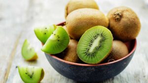 Sliced kiwi fruit showing green flesh and seeds – natural source of fiber and actinidin enzyme