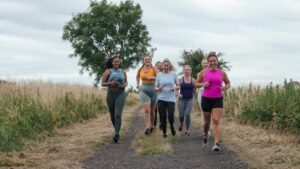 A group of women running shows improved digestive movement and reduced bloating from moderate daily exercise.