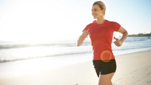 A woman running shows diverse gut bacteria increasing in response to regular physical exercise and how exercise improves gut health.